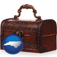 north-carolina map icon and an antique wooden chest